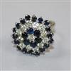 An 18ct white gold, sapphire and diamond cluster ring, size G.                                                                         