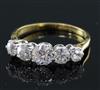 An 18ct gold and platinum, graduated five stone diamond half hoop ring, size M.                                                        