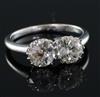 An 18ct white gold and two stone diamond ring, size P/Q.                                                                               