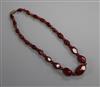 A single strand graduated simulated cherry amber bead necklace, gross weight 25 grams, 42cm.                                           