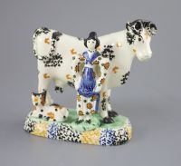 A Yorkshire Prattware 'cow and milkmaid' group, probably Mexborough, c.1820, 15cm high, 16cm long                                      