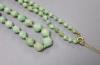 An early 20th century graduated carved jade bead necklace, with 9ct clasp, 47cm, gross weight 30 grams.                                                                                                                     