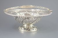 A George III pierced silver pedestal bread basket, with oval ring swing handle,                                                        