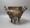 An Oriental two handled elephant footed bronze bowl, 24 cms high not including handles.                                                                                                                                     
