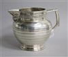 An Edwardian silver jug by Edward Barnard & Sons Ltd, 10.5cm.                                                                          