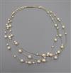 A modern 14ct and cultured pearl triple strand necklace, approx. 34cm.                                                                 