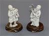 Two carved ivory figures with hardwood stands. tallest 7cm                                                                             