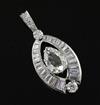 A platinum or white gold, pear, baguette and round cut diamond set elliptical shaped pendant,                                          