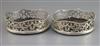 A pair of Victorian foliate-pierced silver bottle coasters with wavy gadrooned rims, London 1841, Charles & George Fox, 14.1cm.        