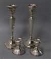 A pair of George V silver candlesticks and a pair of later silver dwarf candlesticks, tallest 20.2cm.                                  