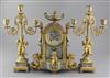 A third quarter of the 19th century French champlevé enamel and ormolu clock garniture, height clock 14in. candelabra 14.75in.         