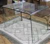 A curved glass table w.127cm.                                                                                                          