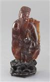 A Chinese amber group of a sage and a boy, Qing dynasty, attached to a wood stand, losses                                              