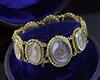 A cased Victorian gold and glazed plaited hair oval panel family memento bracelet,                                                     