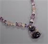 A Chinese amethyst and rock crystal pendant hung from a carved amethyst and rock crystal necklace, pendant 38mm.                       