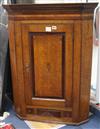 A late 18th century oak and mahogany banded hanging corner cupboard W.76cm                                                             