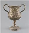 An early 20th century Indian Kutch silver two handled pedestal cup, 20 oz.                                                             