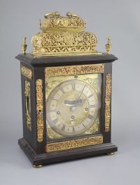 A William III ebonised cased and gilt metal double basket topped chiming and quarter repeating table clock, height 17in.               