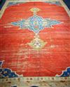 A Persian red ground carpet, worn 415 x 300cm.                                                                                         