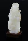 A fine Chinese white and russet jade group of Xi Wangmu and a phoenix, 19th/20th century, 9.5cm high, wood stand                       