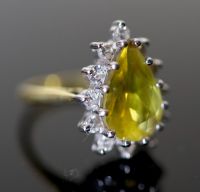 A modern 18ct gold, pear shaped yellow tourmaline and diamond set cluster dress ring,                                                  