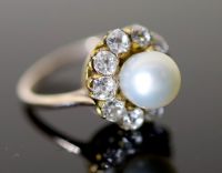 A modern gold, cultured pearl and diamond set circular cluster ring,                                                                   