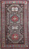 An antique Caucasian polychrome ground rug, 7ft 5in by 4ft 4in.                                                                        