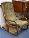 A late Victorian mahogany rocking armchair                                                                                             