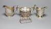 An Edwardian silver cream jug and sugar bowl, Birmingham, 1909, a demi fluted silver cream jug and a silver toastrack                                                                                                       