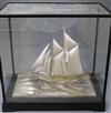 A parcel gilt sterling silver model of a sailing ship, on a stepped ebonised base, in a glazed case, case 41.5cm.                      