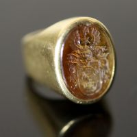 A 20th century continental 18ct gold (stamped 750) and oval citrine? intaglio signet ring,                                             