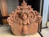 A terracotta cherub head garden wall plaque, width 54cm, height 54cm                                                                                                                                                        