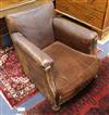 A near pair of early 20th century leather club armchairs, one seat cushion lacking                                                     