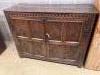 A 17th century carved and panelled oak cupboard                                                                                                                                                                             