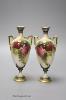 A pair of Royal Worcester two handled vases, decorated with roses, unsigned, 18cm (one a.f.)                                                                                                                                