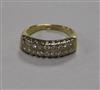 An 18ct gold and twin row diamond half hoop ring (one stone missing), size K.                                                          