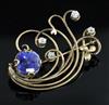 A Ceylonese sapphire and diamond set stylised spray brooch in yellow gold setting, 45mm.                                               