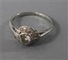 An Art Deco platinum and diamond ring, size M.                                                                                         