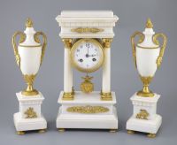 A Louis XVI style ormolu mounted white marble clock garniture, clock 14.5in. urns 13.75in.                                             