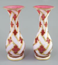 A pair of Bohemian white and ruby overlaid glass baluster vases, late 19th century, 34cm high                                          