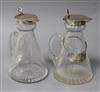 Two George V silver mounted glass whisky tot jugs by Mappin & Webb, Birmingham, 1924, one with a silver label, 11.1cm.                 