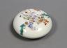 A Chinese famille rose ink box, 9.5 cms diameter.                                                                                                                                                                           