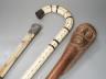 A carved wood figural walking cane, a vertebrae walking stick and a Victorian parasol. Longest 108cm                                                                                                                        