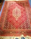 A Persian red ground rug 235cm x 170cm                                                                                                 