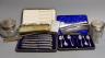 Four assorted silver mounted glass toilet jars, a silver mounted brush, two combs and a shoe horn and two cased sets of cutlery including silver teaspoons with tongs.                                                      