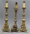 A pair of brass candlesticks and a similar one tallest 39.5cm                                                                          