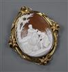 A late Victorian scrolling yellow metal mounted oval cameo brooch, carved with St John the Baptist, 82mm.                              