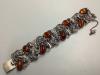 A 925 white metal and amber bracelet of foliate design, gross 56 grams.                                                                                                                                                     