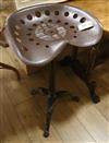 A cast iron base tractor seat stool                                                                                                    