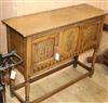 A reproduction oak low cupboard W.107cm                                                                                                